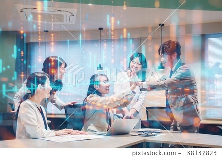 A woman is overjoyed and high-fiving others in the office. 138137823