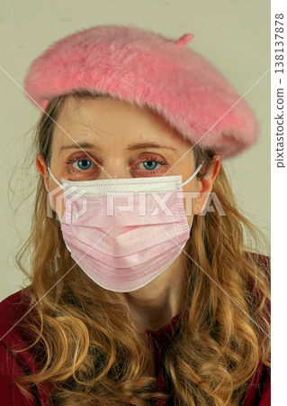 Young woman with face mask and pink hat Young woman with face mask and pink hat 138137878