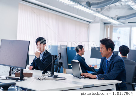 A male office worker working in a brightly lit office A male office worker working in a brightly lit office 138137964