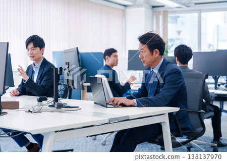 A male office worker working in a brightly lit office A male office worker working in a brightly lit office 138137970
