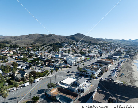 Aerial view of Cayucos, California USA, Pier, Ocean Ave and Shoreline Beach with Green Hills in San Luis Obispo County 138138193