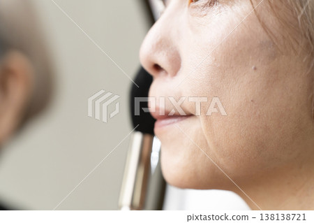 Senior women applying makeup 138138721
