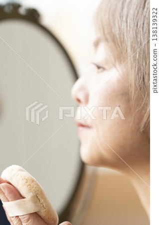 Senior women applying makeup 138139322