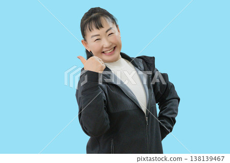 A woman giving a thumbs-up and smiling. 138139467