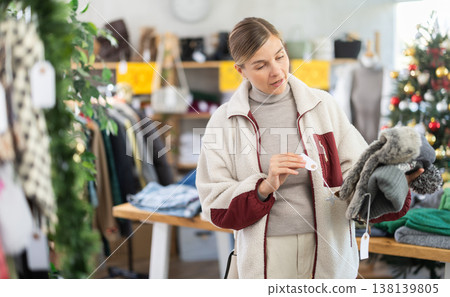 Woman client looks at products in store, choose closely ladys arm hat Woman client looks at products in store, choose closely ladys arm hat 138139805