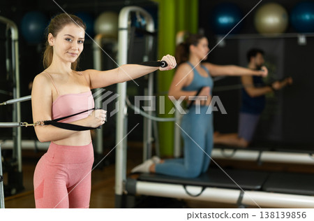 Young woman doing exercises on pilates class 138139856