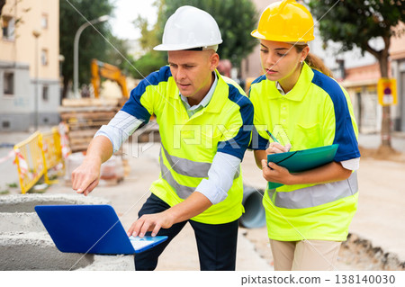 Two builders planning their work in construction plant Two builders planning their work in construction plant 138140030