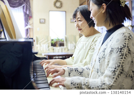 An active senior woman taking piano lessons. An active senior woman taking piano lessons. 138140154