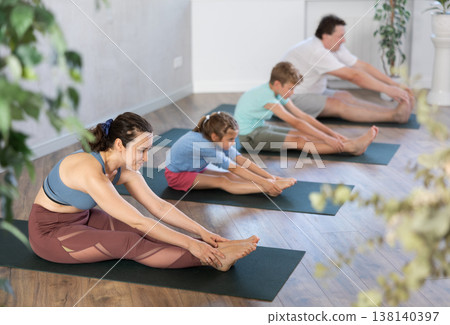 Family with two children doing pilates in studio Family with two children doing pilates in studio 138140397