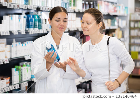 In cosmetic department of pharmacy, buyer asks consultant to help and choose cleansing gel. In cosmetic department of pharmacy, buyer asks consultant to help and choose cleansing gel. 138140464