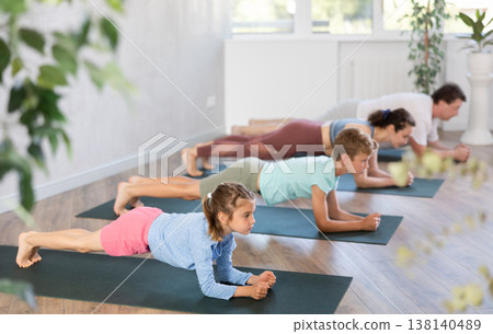 Family with two children doing pilates in studio Family with two children doing pilates in studio 138140489