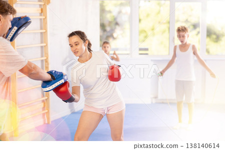 Man and woman training boxing in studio Man and woman training boxing in studio 138140614