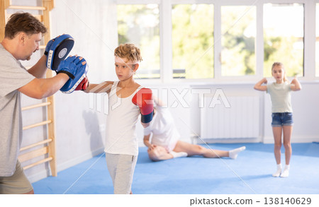 Father and son training boxing in studio Father and son training boxing in studio 138140629