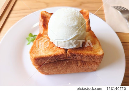 A cafe-style dessert: thick slices of toast topped with vanilla ice cream. A cafe-style dessert: thick slices of toast topped with vanilla ice cream. 138140750