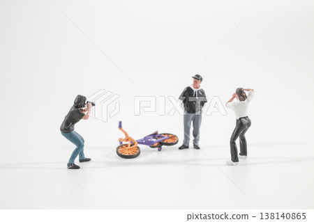 Miniature Figures Photographing Scene Around Fallen Colorful Bicycle Miniature Figures Photographing Scene Around Fallen Colorful Bicycle 138140865