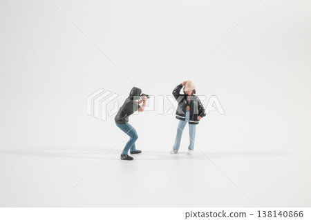 Miniature Photographer Taking Picture of Posed Figure Indoors 138140866