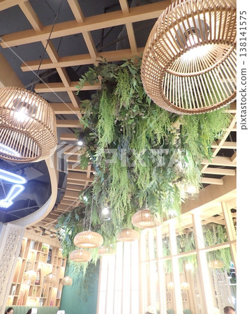 Close-up of rattan lighting and ceiling greenery: Natural interior Close-up of rattan lighting and ceiling greenery: Natural interior 138141575