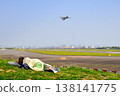 A woman taking a break while watching airplanes. 138141775