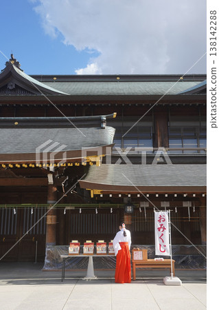 An image of a shrine maiden standing in front of the fortune-telling slips at a shrine. An image of a shrine maiden standing in front of the fortune-telling slips at a shrine. 138142288