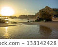 Golden hour idyllic vacation beach scene Algarve Portugal Praia do Amado big sun 138142428