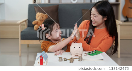 Mother and daughter celebrating financial learning Mother and daughter celebrating financial learning 138142473