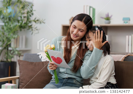 Mother and daughter sharing a heartfelt Mother's Day moment Mother and daughter sharing a heartfelt Mother's Day moment 138142477