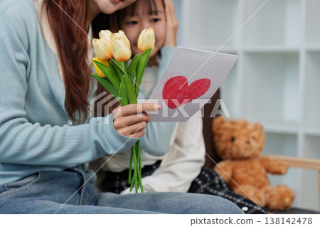Mother's Day celebration with a handmade card and flowers Mother's Day celebration with a handmade card and flowers 138142478