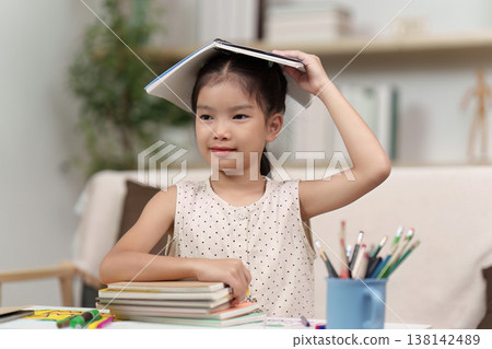 Playful Back to School Moment with Child and Books 138142489