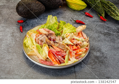Hearty pasta salad with tuna and fresh vegetables on a dark, textured surface 138142547
