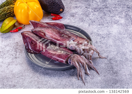 Fresh raw squid on a plate with exotic vegetables for cooking Fresh raw squid on a plate with exotic vegetables for cooking 138142569