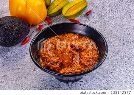 Indian butter chicken masala, a spicy traditional curry served in a bowl on a textured background. Indian butter chicken masala, a spicy traditional curry served in a bowl on a textured background. 138142577