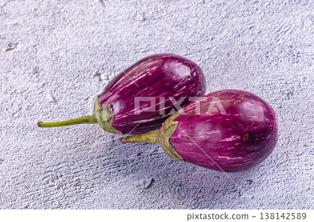 Fresh striped graffiti eggplants on a rustic table Fresh striped graffiti eggplants on a rustic table 138142589