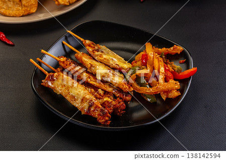 Grilled Chicken Skewers with Melted Cheese and Vegetables 138142594