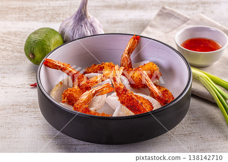 Crispy fried panko shrimp in a bowl with sweet chili sauce and fresh ingredients 138142710