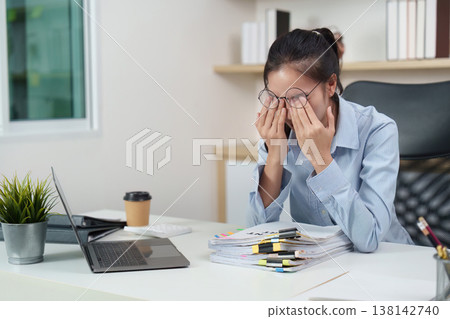 Office syndrome concept with woman rubbing eyes at desk Office syndrome concept with woman rubbing eyes at desk 138142740