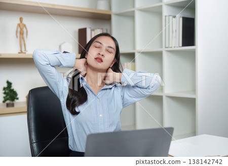 Office syndrome concept with woman massaging neck in workplace Office syndrome concept with woman massaging neck in workplace 138142742