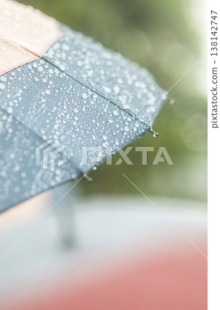 Raindrops on an umbrella, rainy season, rain image Raindrops on an umbrella, rainy season, rain image 138142747