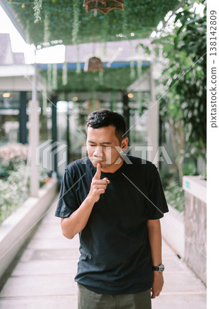 Man making silence gesture with finger on lips asking to be quiet Man making silence gesture with finger on lips asking to be quiet 138142809