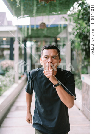 Man asking for silence with finger on lips in quiet or secret concept Man asking for silence with finger on lips in quiet or secret concept 138142811