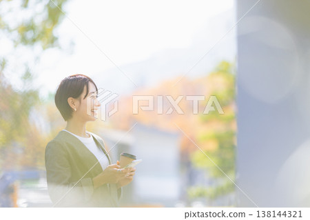 A woman enjoying autumn leaves 138144321