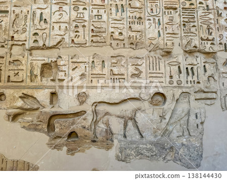 Beautiful bas-reliefs and ancient hieroglyphs from the mortuary temple of Ramesses III at Medinet Habu, Luxor, Egypt. 138144430