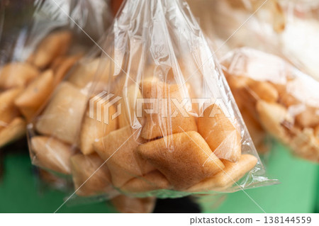 Traditional Northern Thai crispy rice crackers called Khao Kuap in transparent plastic bags from Chiang Mai Thailand 138144559