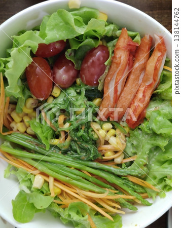 Fresh Mixed Salad Bowl with Lettuce, Crab sticks, Carrot Strips, Corn, Leafy Greens, and Assorted Vegetables Arranged in a White Round Dish Fresh Mixed Salad Bowl with Lettuce, Crab sticks, Carrot Strips, Corn, Leafy Greens, and Assorted Vegetables Arranged in a White Round Dish 138144762