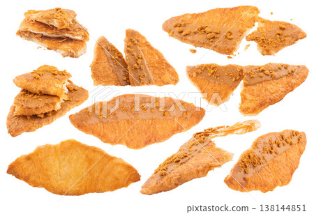 Set of flat and crispy croissants with caramel sauce and cookie crumbs topping, clipping path included 138144851