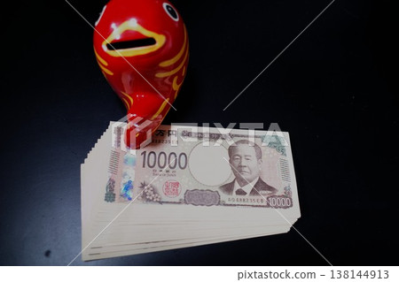 A red piggy bank and banknotes A red piggy bank and banknotes 138144913