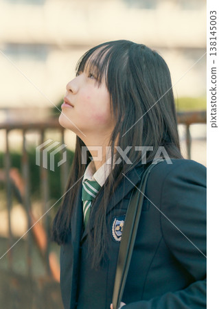 A portrait of a female student's profile, looking up in an emotionally evocative light. A portrait of a female student's profile, looking up in an emotionally evocative light. 138145003