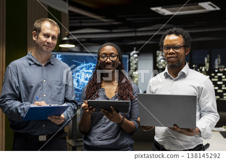 Portrait of happy teamworking programmers utilizing AI to optimize performance and forecast issues. Joyous coworkers in tech startup office training machine learning models 138145292