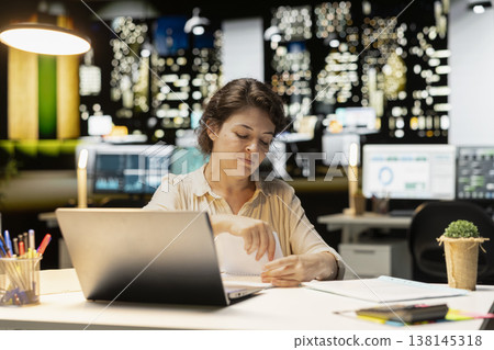 Professional woman breaking a paper after writing the wrong idea, restarting her work in rage and crumpling the page sheet, Discontent woman does a typo mistake while transcribing. Professional woman breaking a paper after writing the wrong idea, restarting her work in rage and crumpling the page sheet, Discontent woman does a typo mistake while transcribing. 138145318