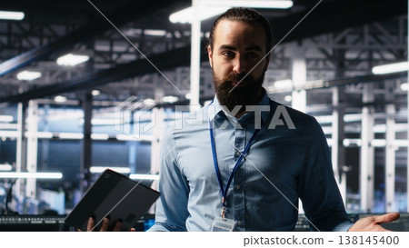Data center system administrator showcasing supercomputers gear and AI technology, filming presentation tour. Server room IT expert presenting artificial intelligence neural networks tech, camera A 138145400