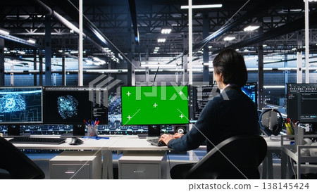 Data center technician uses machine learning algorithms on isolated screen PC to analyze datasets. Server hub worker uses AI neural networks on chroma key computer to recognize data patterns, camera A 138145424
